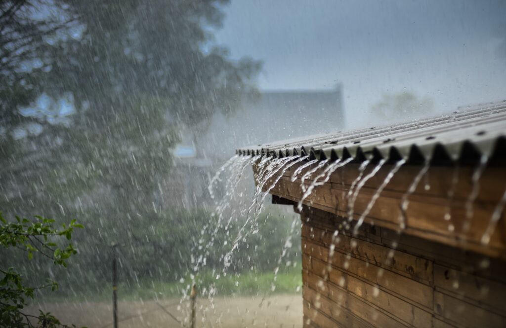 Hard rain flowing from a roof and gutters